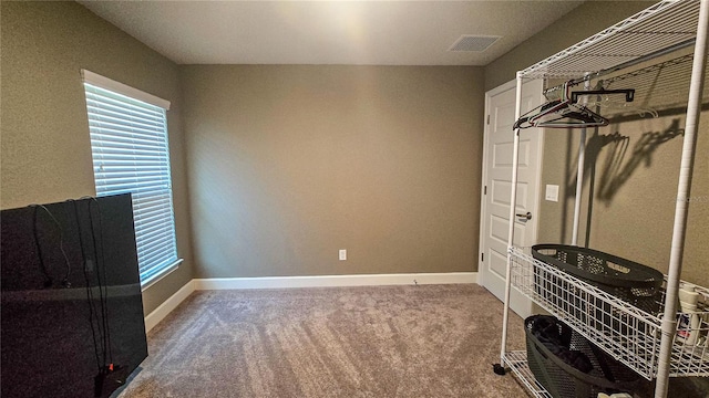 interior space with carpet flooring, visible vents, and baseboards