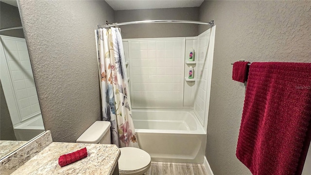 full bath featuring shower / tub combo with curtain, a textured wall, toilet, vanity, and wood finished floors