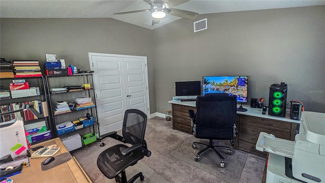 carpeted office featuring visible vents, vaulted ceiling, baseboards, and ceiling fan