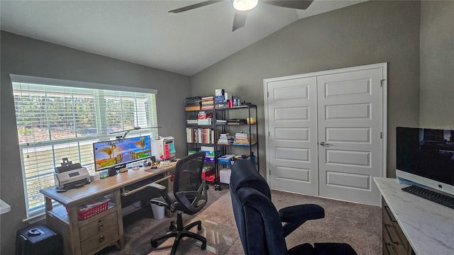 office featuring vaulted ceiling, a ceiling fan, and carpet flooring