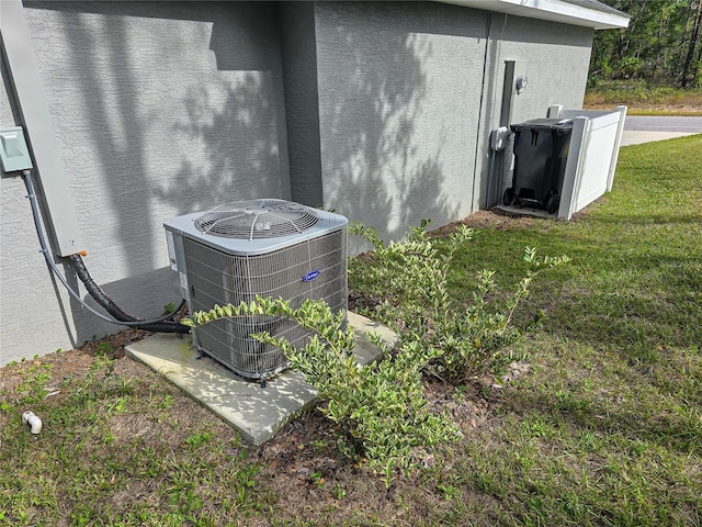 details with central AC unit and stucco siding