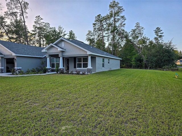 craftsman inspired home with a front lawn