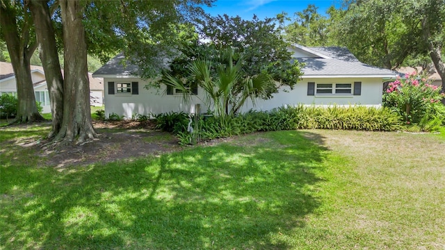 exterior space featuring a lawn and stucco siding