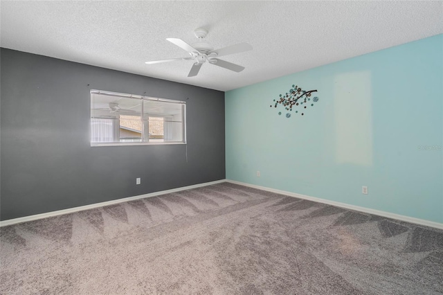 unfurnished room featuring carpet floors, a textured ceiling, baseboards, and a ceiling fan