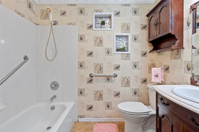 bathroom with bathtub / shower combination, toilet, vanity, baseboards, and wallpapered walls