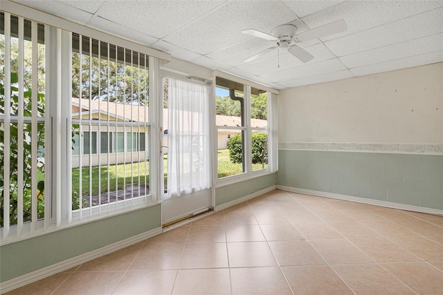 unfurnished sunroom with a paneled ceiling and a ceiling fan