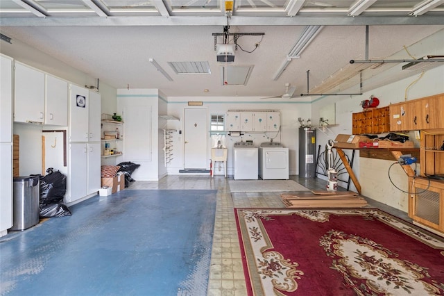 garage with water heater, separate washer and dryer, a sink, and a garage door opener