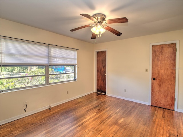 unfurnished room with ceiling fan, baseboards, and wood finished floors