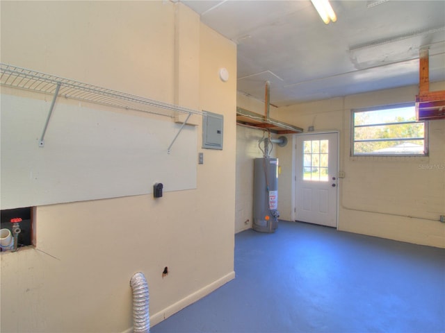 garage featuring electric panel and water heater