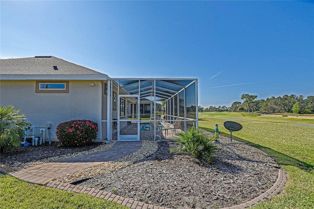 exterior space featuring a patio area, glass enclosure, and an outdoor pool