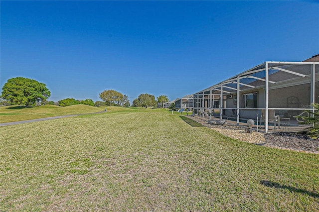 view of yard with glass enclosure