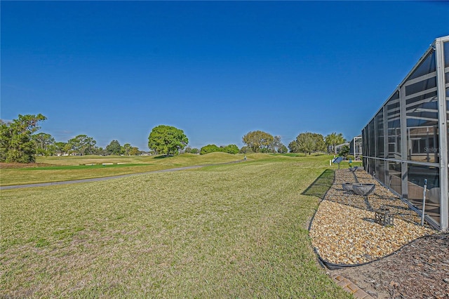 view of yard featuring glass enclosure