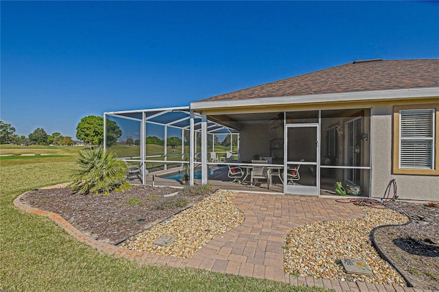 exterior space with a lanai and an outdoor pool