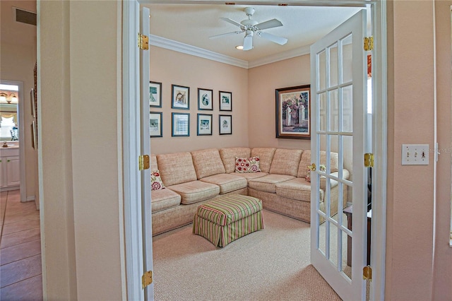 living area featuring french doors, ornamental molding, and a ceiling fan