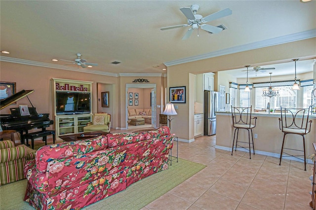 living area with ceiling fan, baseboards, ornamental molding, and light tile patterned flooring