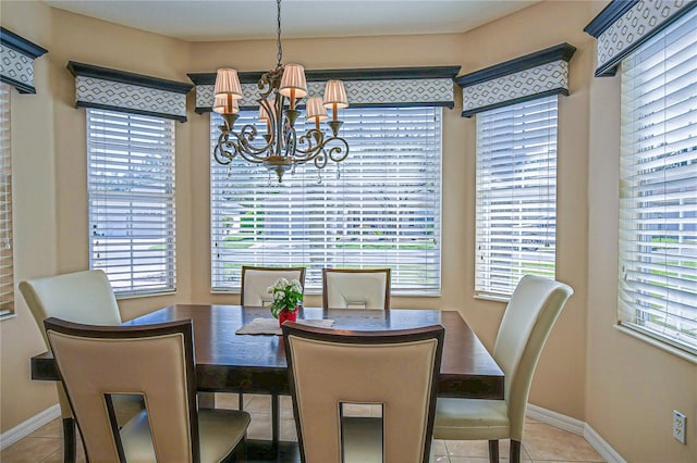 dining room featuring a chandelier, plenty of natural light, baseboards, and tile patterned floors