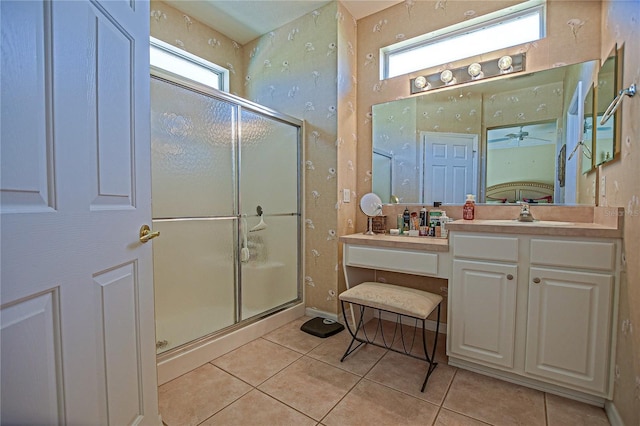 bathroom featuring a shower stall, vanity, baseboards, and tile patterned floors