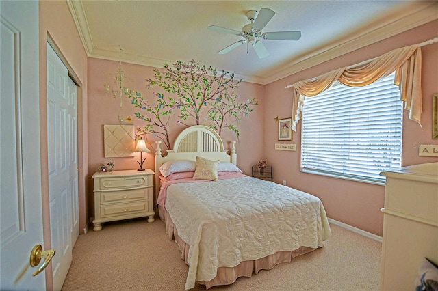 bedroom featuring a closet, ornamental molding, a ceiling fan, light carpet, and baseboards