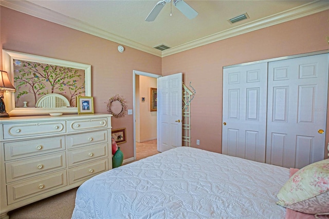 bedroom featuring a ceiling fan, visible vents, a closet, and ornamental molding