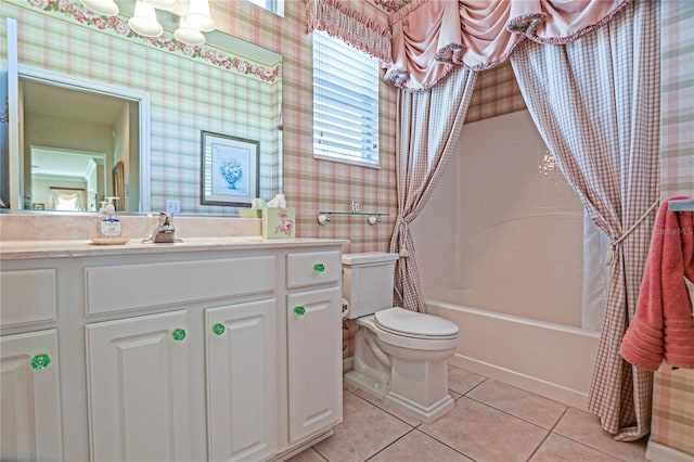 bathroom with toilet, wallpapered walls, vanity, and tile patterned floors