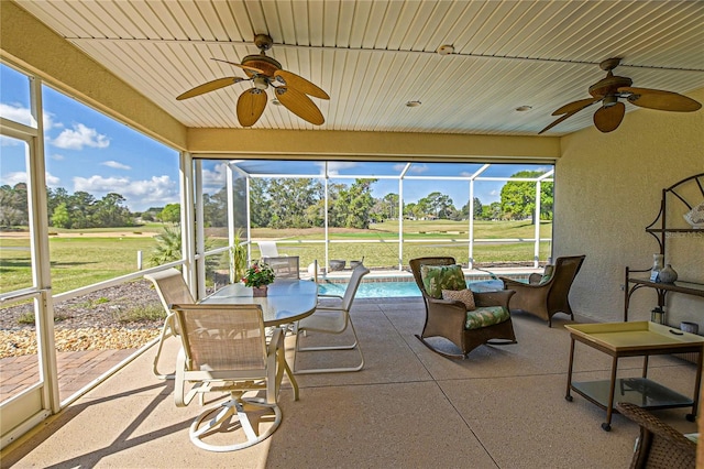 sunroom featuring wooden ceiling, plenty of natural light, and ceiling fan