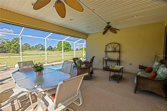 view of patio featuring outdoor dining area, a lanai, a ceiling fan, and an outdoor pool