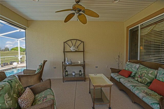 exterior space featuring a ceiling fan, glass enclosure, an outdoor pool, and an outdoor living space