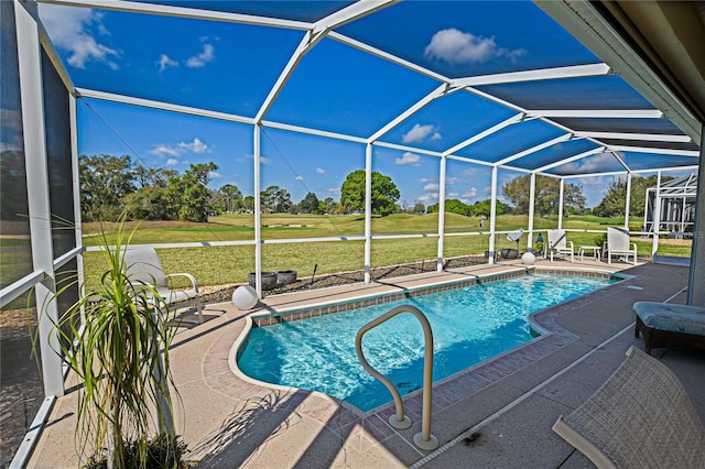 outdoor pool with a yard, a patio, and glass enclosure