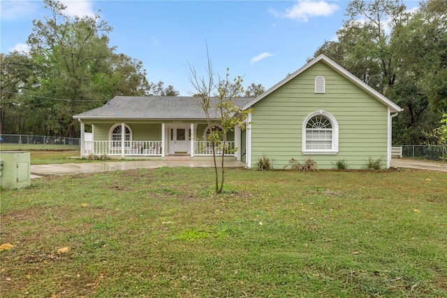 ranch-style home with covered porch, a front yard, and fence