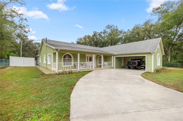 ranch-style house with driveway, an attached garage, covered porch, fence, and a front yard