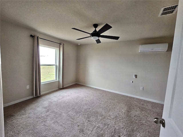 carpeted spare room featuring baseboards, visible vents, a ceiling fan, a textured ceiling, and an AC wall unit