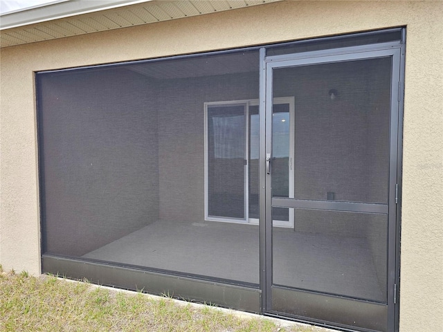 doorway to property with stucco siding