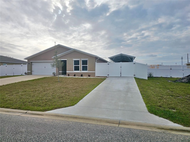 view of front of property with a front lawn, a gate, concrete driveway, and stucco siding