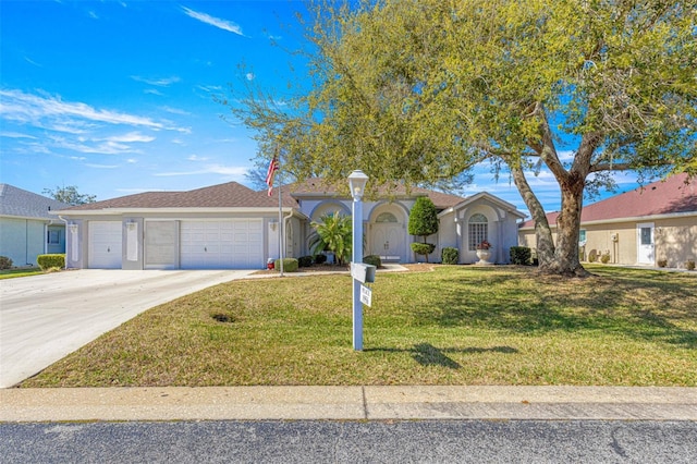 ranch-style house featuring a front lawn, driveway, an attached garage, and stucco siding