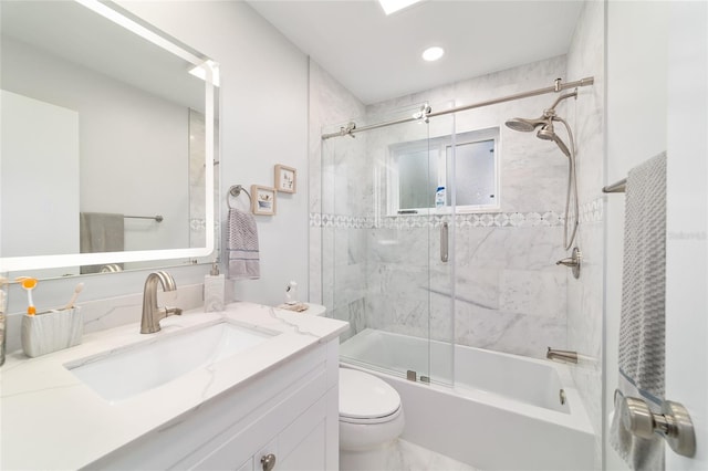 full bathroom featuring combined bath / shower with glass door, vanity, and toilet