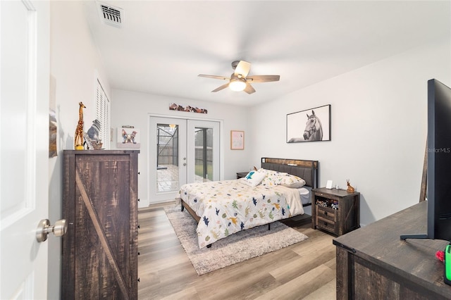 bedroom featuring french doors, light wood finished floors, visible vents, ceiling fan, and access to outside