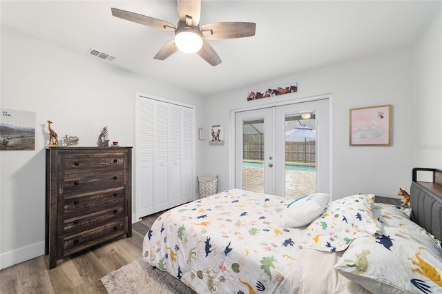 bedroom featuring visible vents, light wood-style flooring, access to exterior, french doors, and a closet