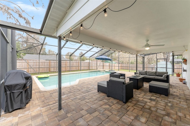 view of pool featuring an outdoor hangout area, a storage unit, a patio area, and a fenced backyard