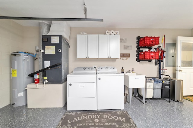 laundry room with washing machine and dryer, water heater, cabinet space, electric panel, and concrete block wall