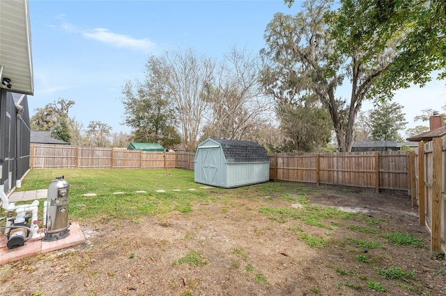 view of yard with an outbuilding, a shed, and a fenced backyard