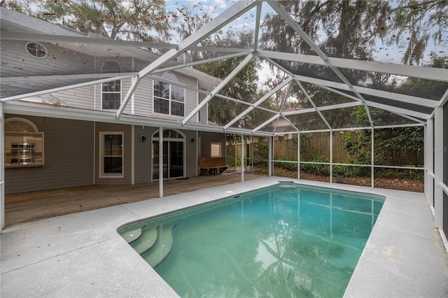 pool featuring glass enclosure and a wooden deck