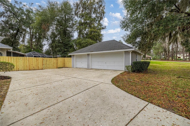 detached garage featuring fence