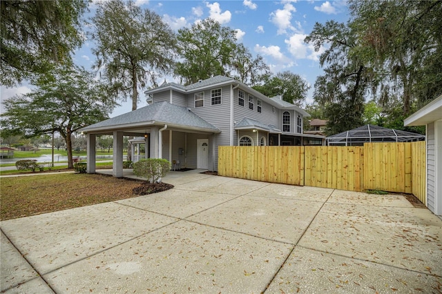 view of front of home featuring a shingled roof and a lanai