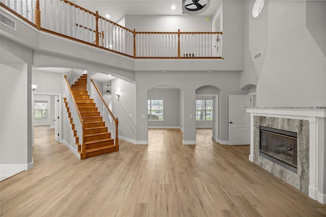 unfurnished living room featuring a healthy amount of sunlight, light wood-type flooring, and baseboards