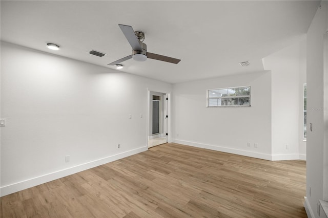 empty room with light wood-type flooring, baseboards, visible vents, and a ceiling fan