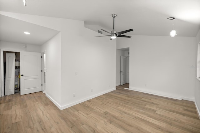 empty room with lofted ceiling, baseboards, ceiling fan, and light wood finished floors