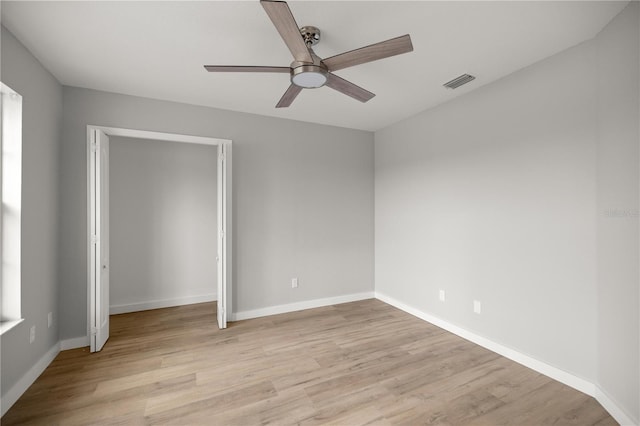 unfurnished bedroom with baseboards, ceiling fan, visible vents, and light wood-style floors