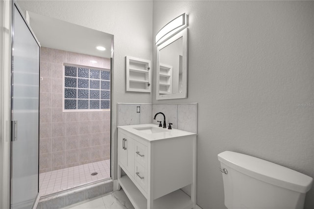 full bath featuring a textured wall, toilet, vanity, marble finish floor, and a stall shower