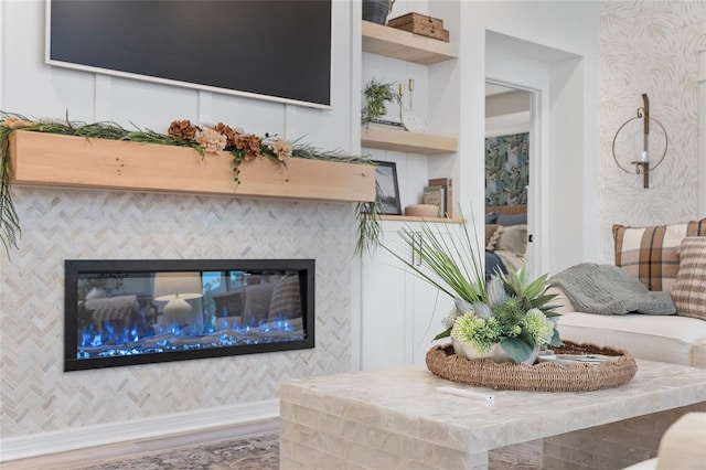 details featuring baseboards, a fireplace, wood finished floors, and wallpapered walls