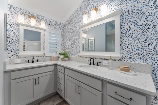 full bath featuring vanity and wallpapered walls